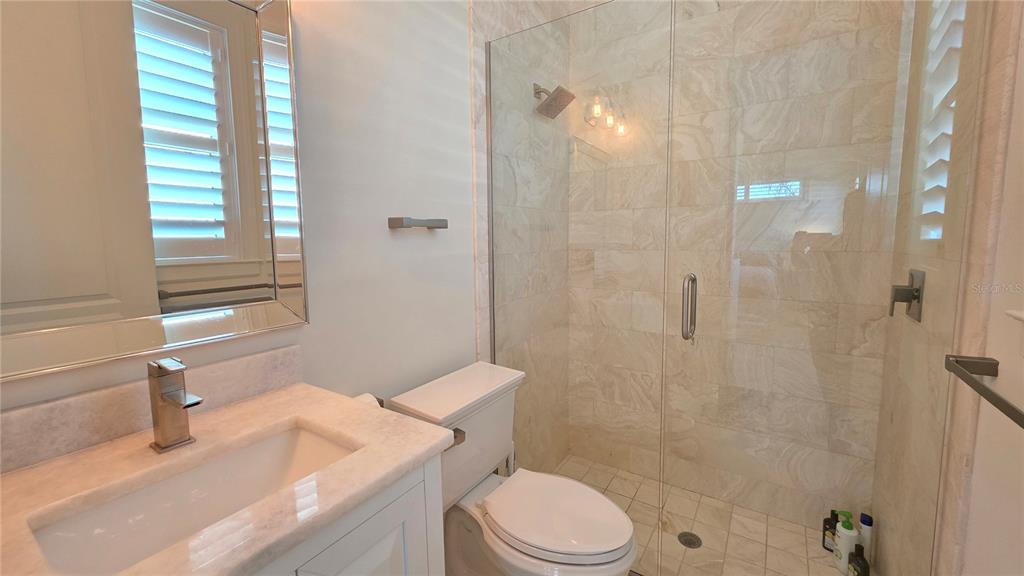 531 Birdie Lane Longboat Key, FL 34228 - Photo 28 of 43 a bathroom with a sink a toilet and shower