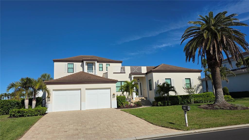 531 Birdie Lane Longboat Key, FL 34228 - Photo 3 of 43 a front view of a house with a garden