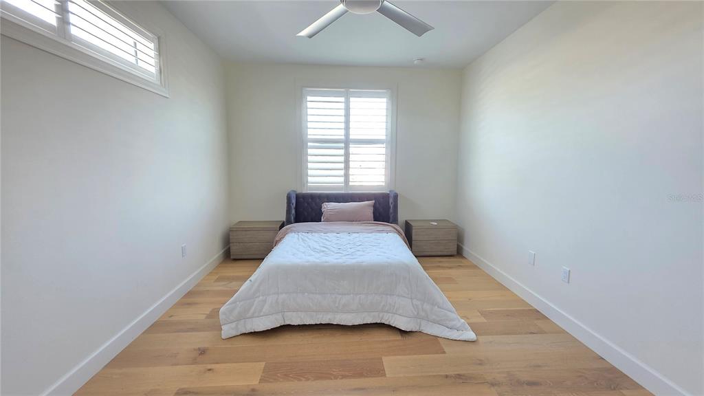 531 Birdie Lane Longboat Key, FL 34228 - Photo 32 of 43 a bedroom with a bed and a window