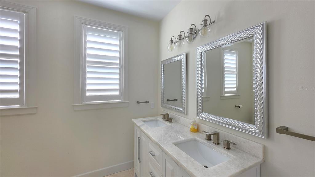 531 Birdie Lane Longboat Key, FL 34228 - Photo 35 of 43 a bathroom with a sink vanity and mirror