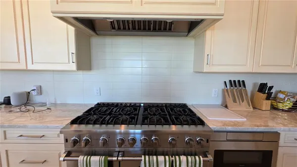 a kitchen with a stove and cabinets