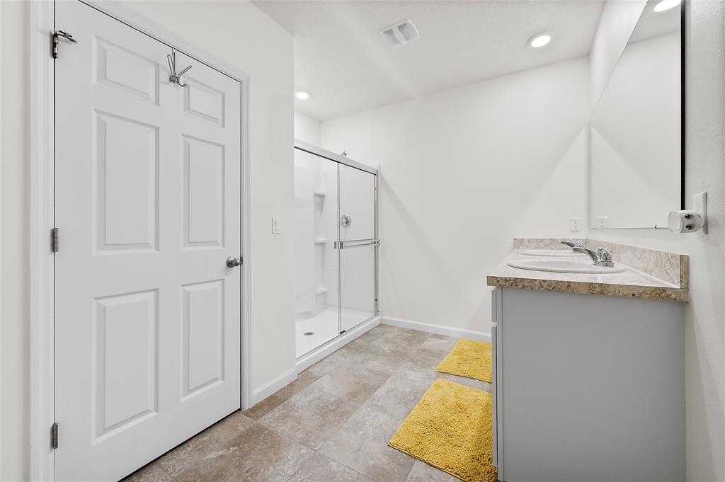 6295 Northwest Regent Street Port St. Lucie, FL 34983 - Photo 14 of 22 a bathroom with a sink and a mirror