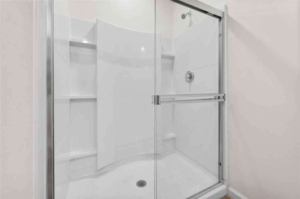 6295 Northwest Regent Street Port St. Lucie, FL 34983 - Photo 15 of 22 a bathroom with a glass shower door