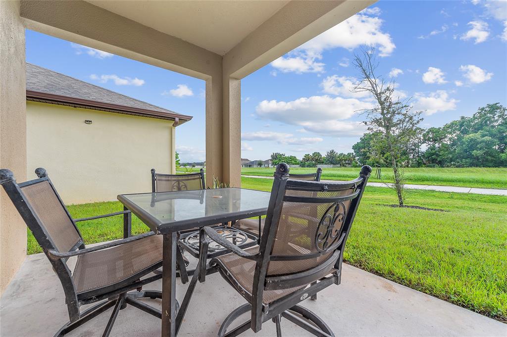 6295 Northwest Regent Street Port St. Lucie, FL 34983 - Photo 19 of 22 a view of a chairs and table in the garden
