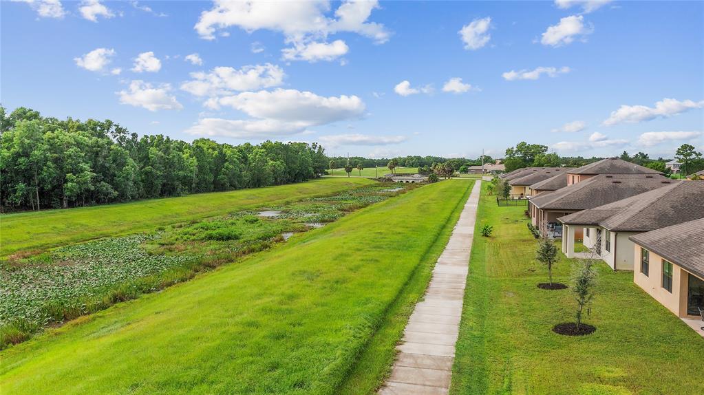 6295 Northwest Regent Street Port St. Lucie, FL 34983 - Photo 22 of 22 a view of a lake with a yard
