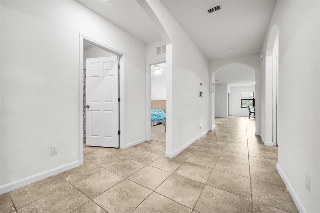 6295 Northwest Regent Street Port St. Lucie, FL 34983 - Photo 3 of 22 a view of a hallway with wooden shelves