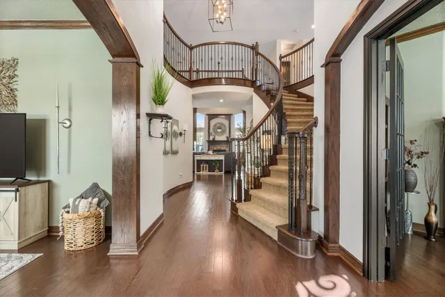 a view of a hallway with wooden floor fireplace and living room