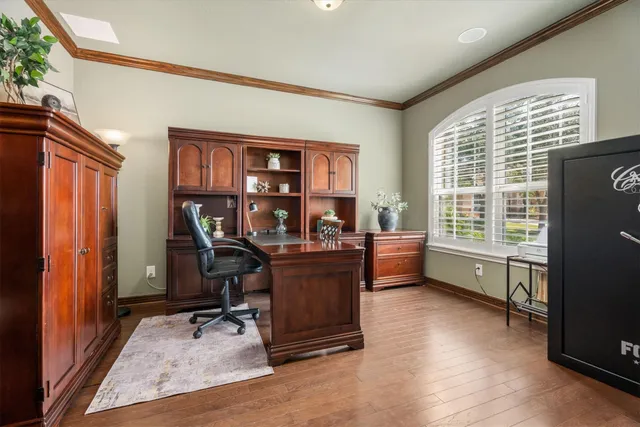 a view of a workspace with furniture and a window