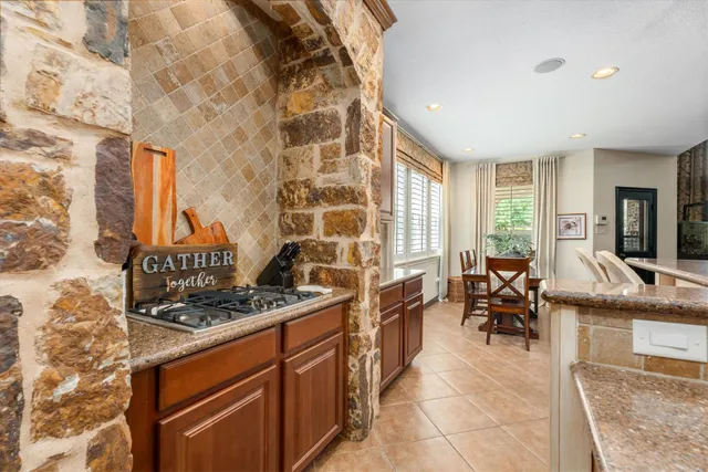 a kitchen with stainless steel appliances granite countertop a stove and a sink