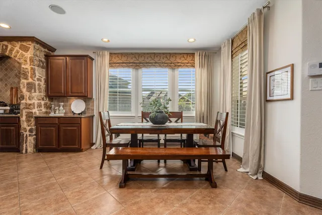 a dining room with furniture and window