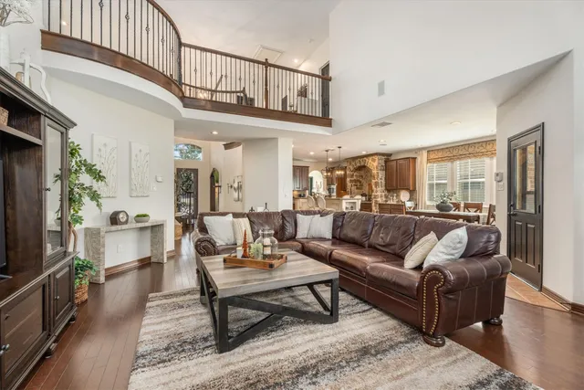 a living room with furniture a rug and a chandelier