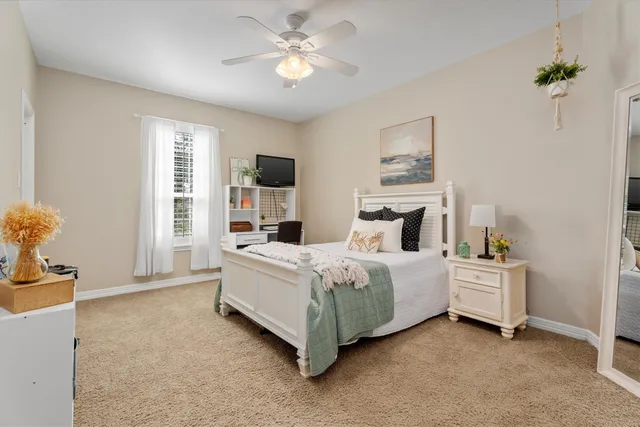 a bed room with a bed and a chandelier