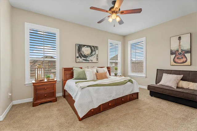 a bedroom with a bed a couch and a window