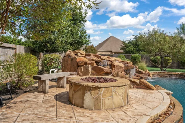a view of a patio with table and chairs and potted plants