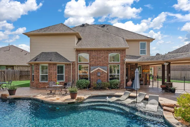 a front view of a house with garden and patio