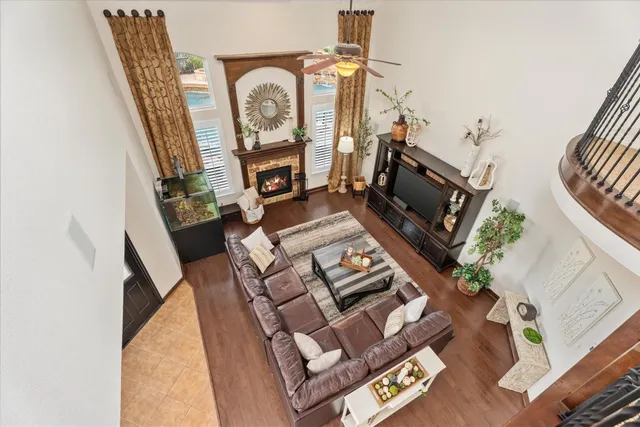 a living room with furniture a fireplace and a floor to ceiling window