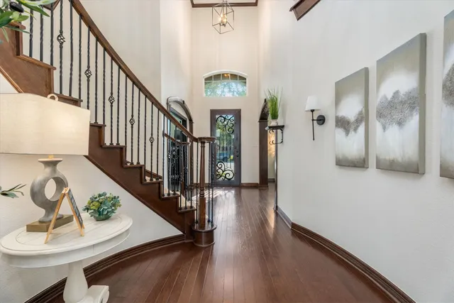 a view of entryway and hall with wooden floor