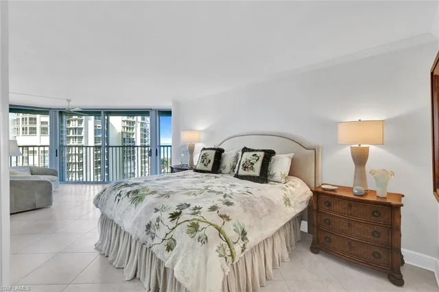 a bed sitting in a spacious bedroom next to a window