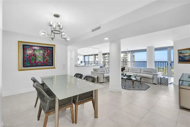 a large white kitchen with lots of counter space and glass door