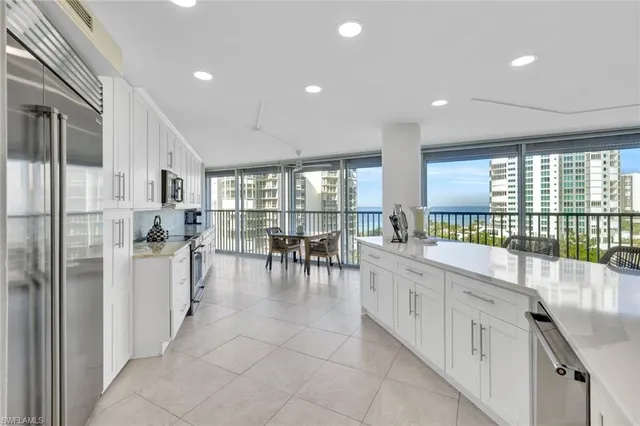 a kitchen that has a lot of cabinets in it and appliances