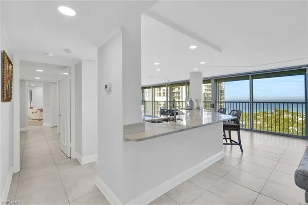 a open kitchen with granite countertop a stove a sink and a microwave