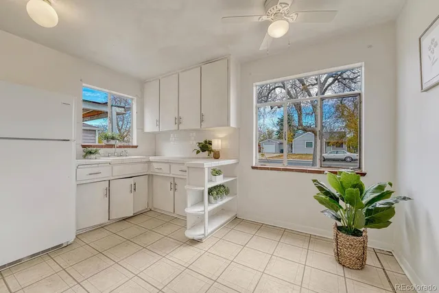 a kitchen with a refrigerator and window