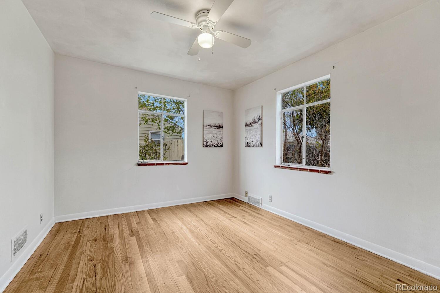765 Moline Street Aurora, CO 80010 - Photo 20 of 26 a view of an empty room with wooden floor and a window