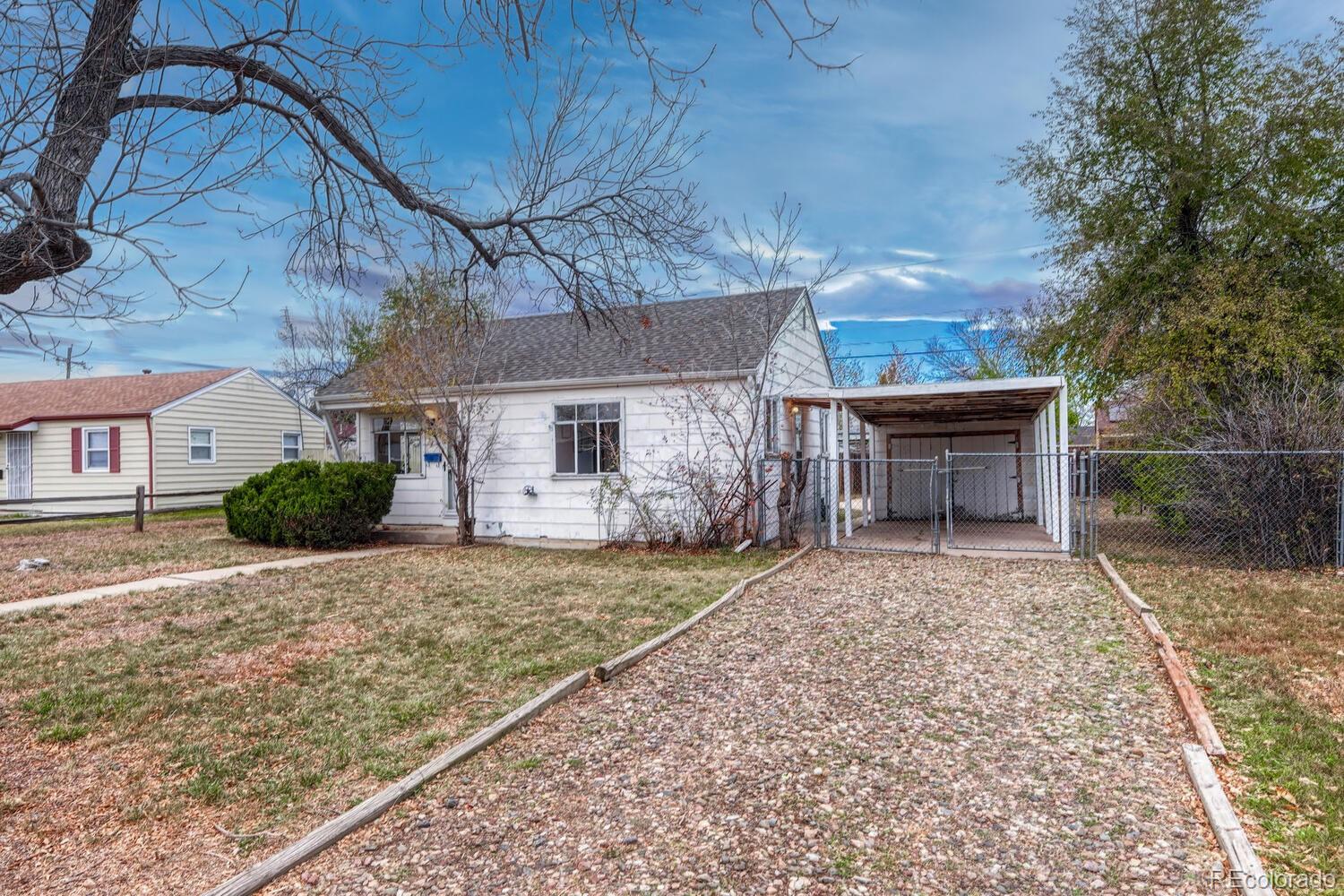 765 Moline Street Aurora, CO 80010 - Photo 3 of 26 a front view of a house with a yard and garage