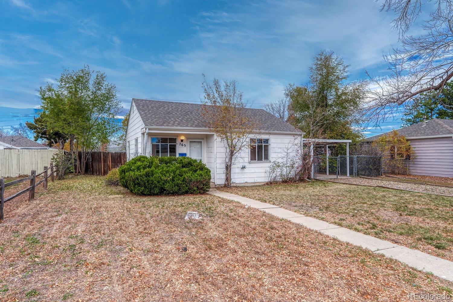 765 Moline Street Aurora, CO 80010 - Photo 4 of 26 a front view of a house with a yard and garage