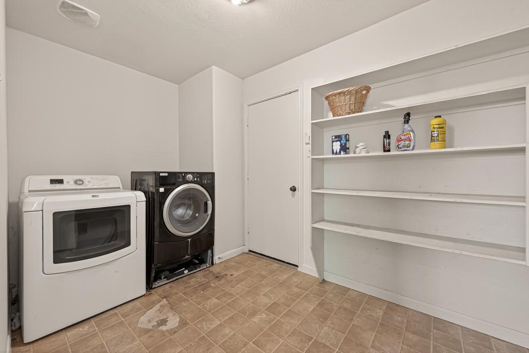 23514 Hidden Maple Drive Spring, TX 77373 - Photo 11 of 23 a view of washer and dryer with racks on the wall