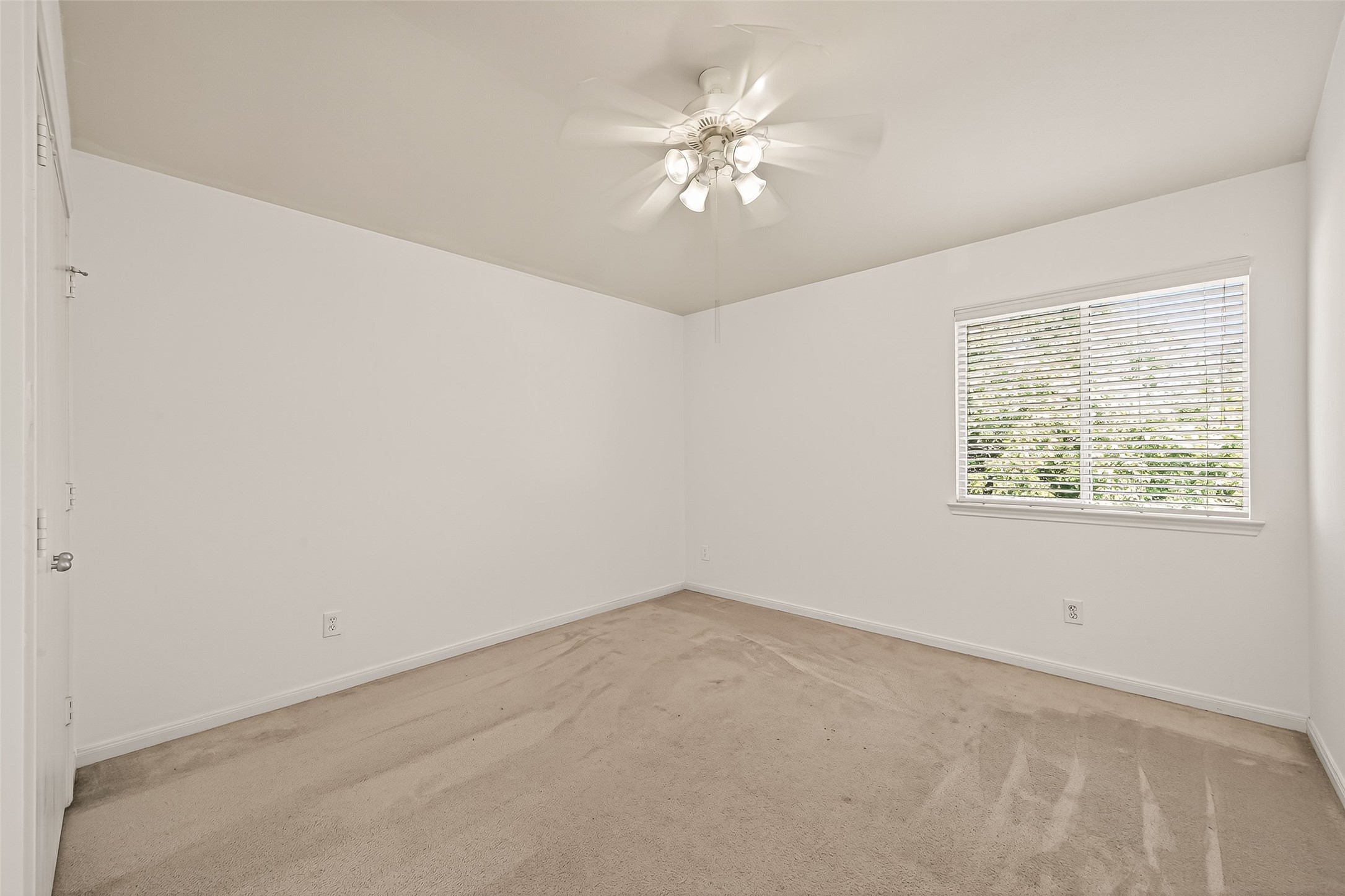 23514 Hidden Maple Drive Spring, TX 77373 - Photo 14 of 23 an empty room with a chandelier fan and windows