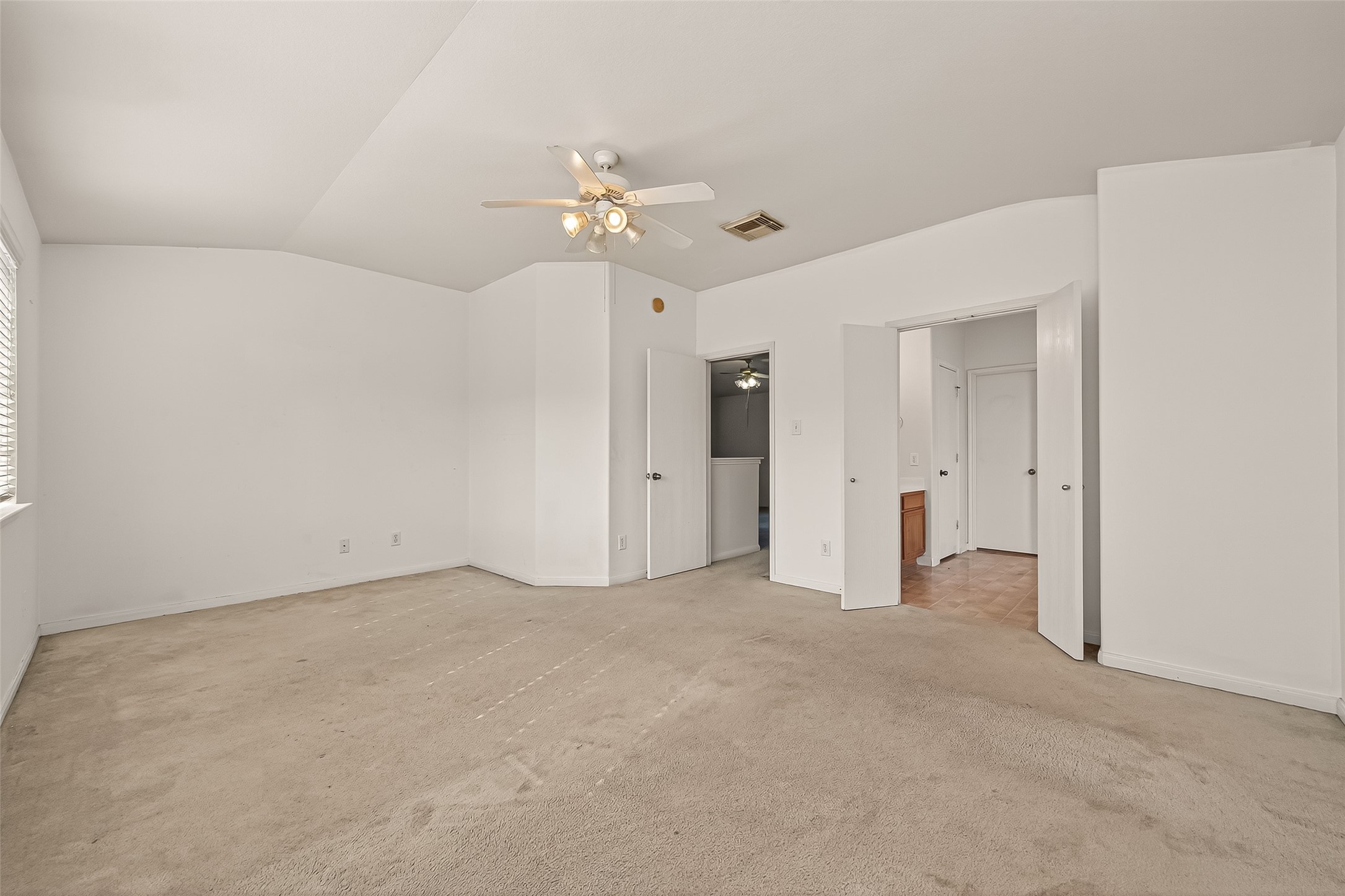 23514 Hidden Maple Drive Spring, TX 77373 - Photo 17 of 23 an empty room with chandelier fan and closet area