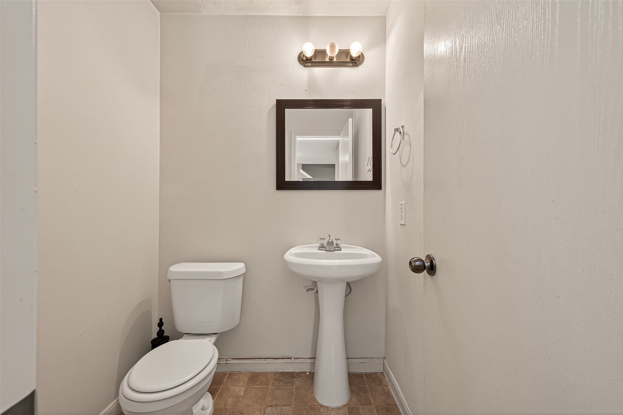 23514 Hidden Maple Drive Spring, TX 77373 - Photo 5 of 23 a bathroom with a toilet sink and mirror