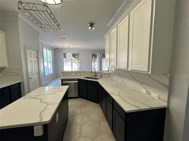 a kitchen with stainless steel appliances granite countertop a sink counter space cabinets and a counter top space