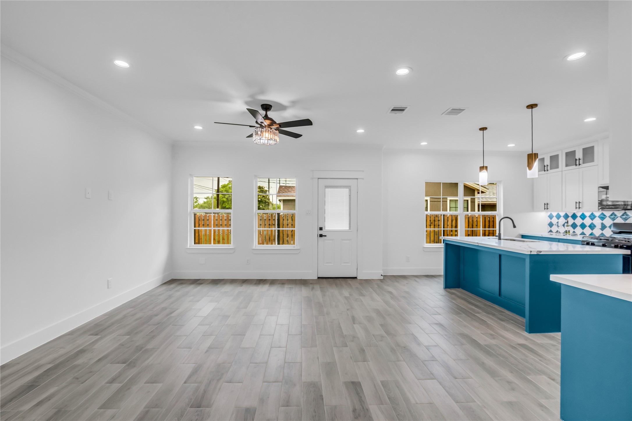 3168 Golfcrest Houston, TX 77087 - Photo 3 of 30 Bright and spacious, this modern living room flows seamlessly into an open-concept kitchen, featuring sleek finishes and abundant natural light, perfect for both relaxation and entertaining.