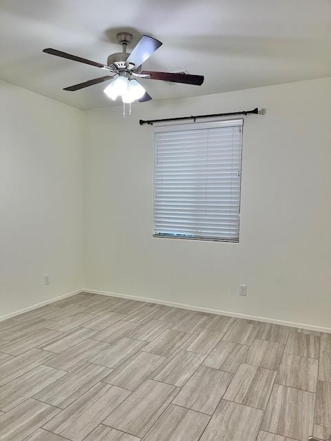 71 West Megan Street Gilbert, AZ 85233 - Photo 15 of 39 a view of a room with wooden floor and a ceiling fan