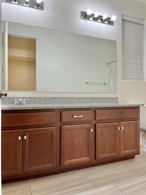 71 West Megan Street Gilbert, AZ 85233 - Photo 16 of 39 a sink with a granite countertop cabinets and white countertops with wooden floor