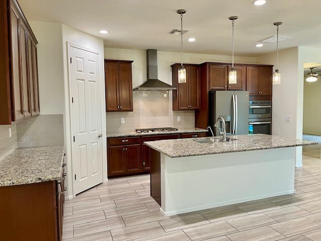 71 West Megan Street Gilbert, AZ 85233 - Photo 3 of 39 a large kitchen with granite countertop a sink and a refrigerator
