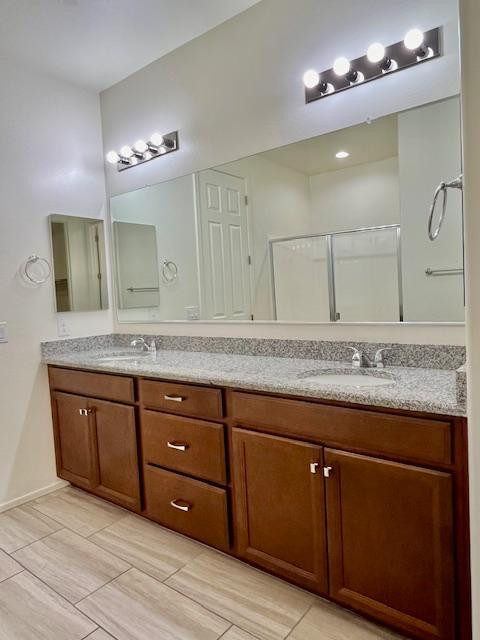 71 West Megan Street Gilbert, AZ 85233 - Photo 32 of 39 a bathroom with a granite countertop double vanity sink and a mirror