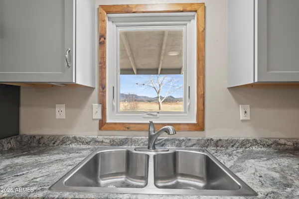 a kitchen with a sink and a granite counter top