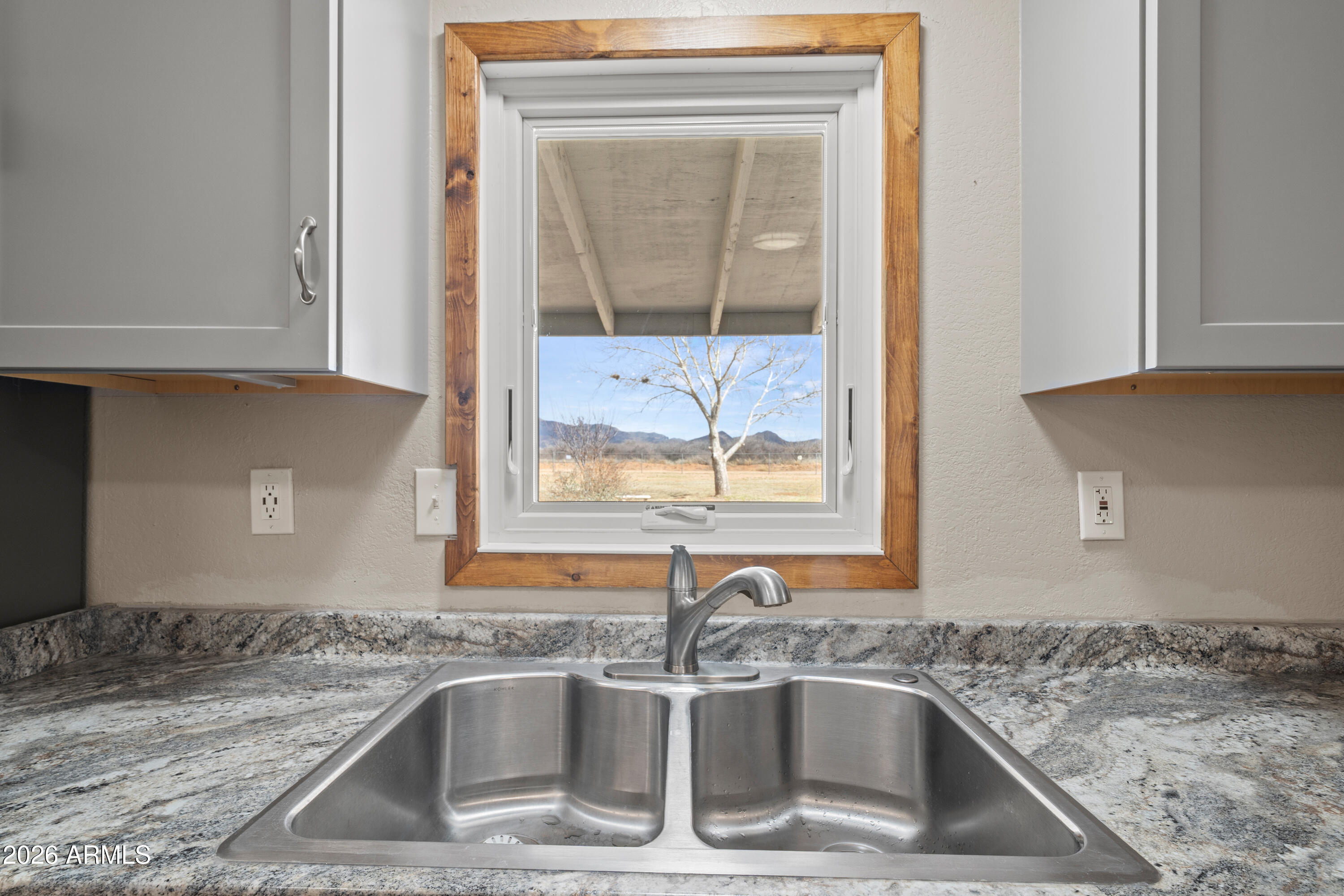 10072 South Shiloh Ranch Road Hereford, AZ 85615 - Photo 11 of 46 a kitchen with a sink and a granite counter top
