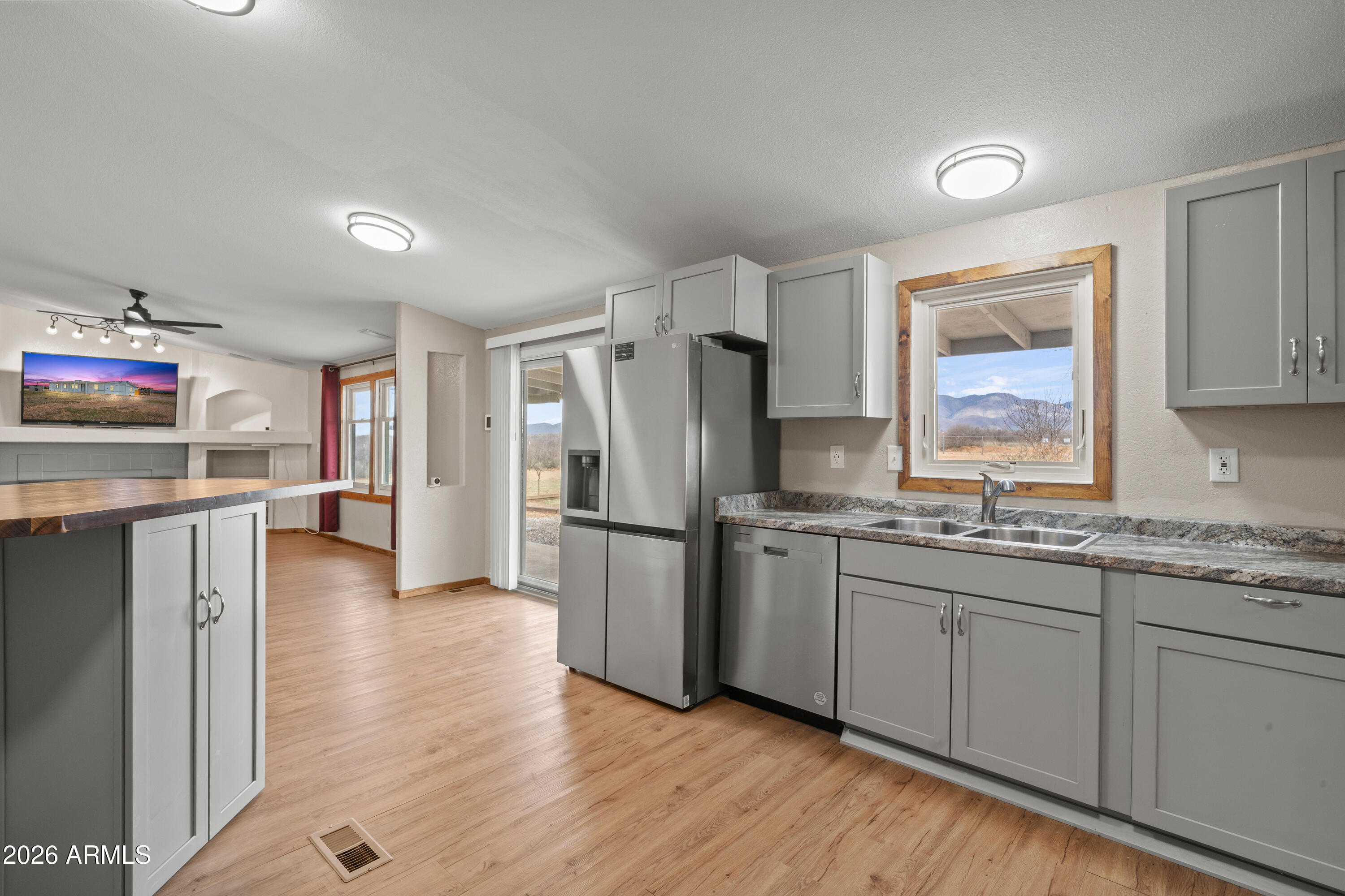 10072 South Shiloh Ranch Road Hereford, AZ 85615 - Photo 13 of 46 a kitchen with stainless steel appliances granite countertop a refrigerator and a stove top oven
