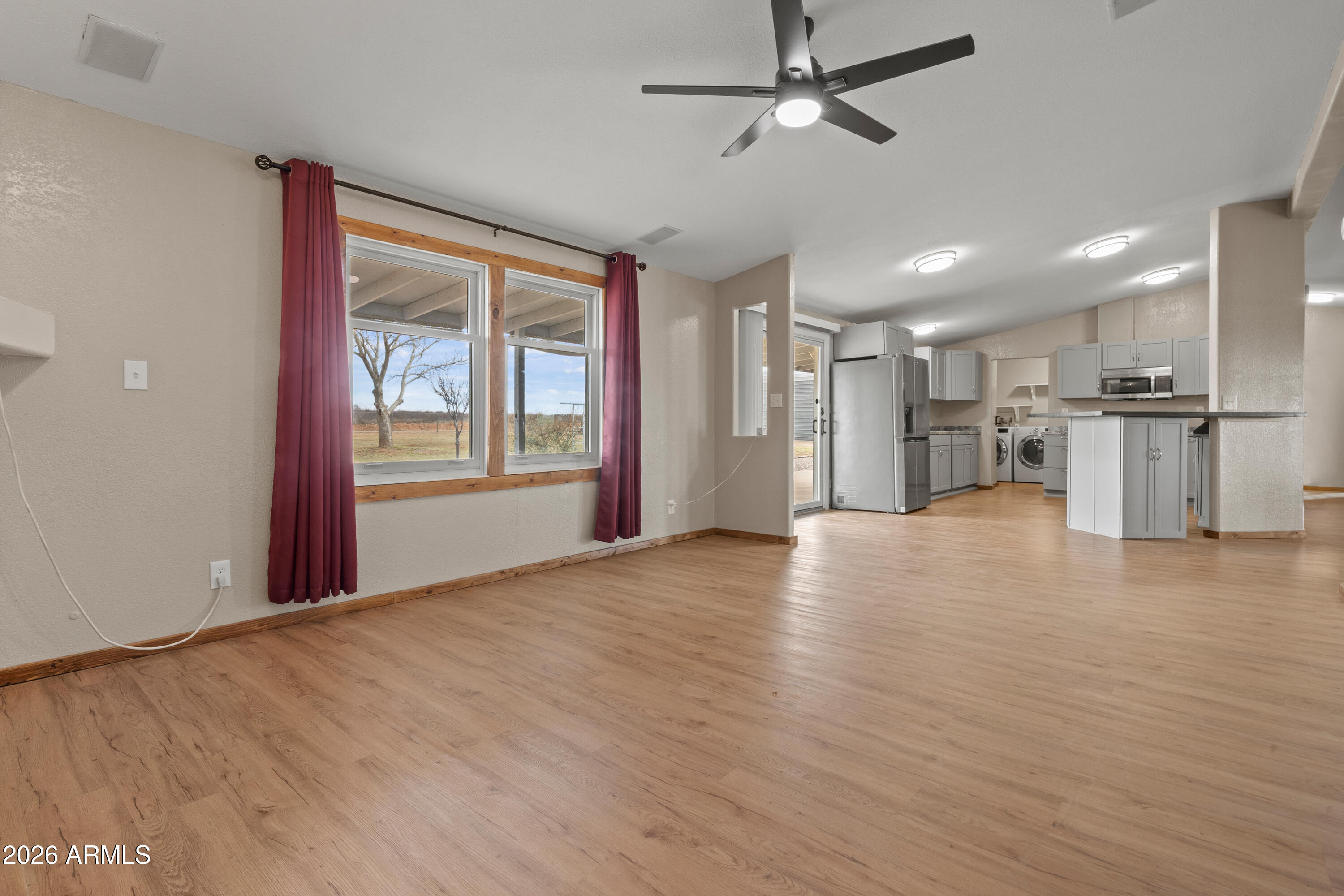 10072 South Shiloh Ranch Road Hereford, AZ 85615 - Photo 14 of 46 a view of empty room with wooden floor and window