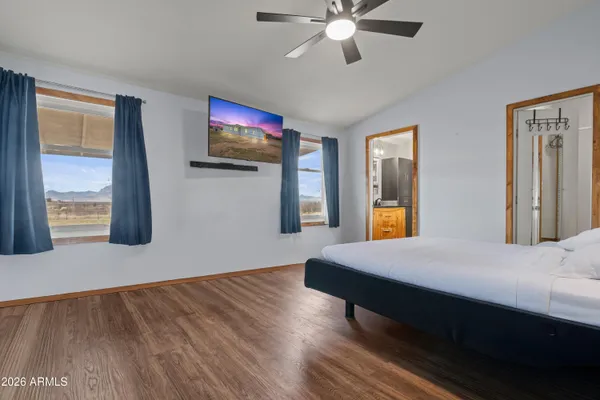 a living room with a bed furniture and a large window