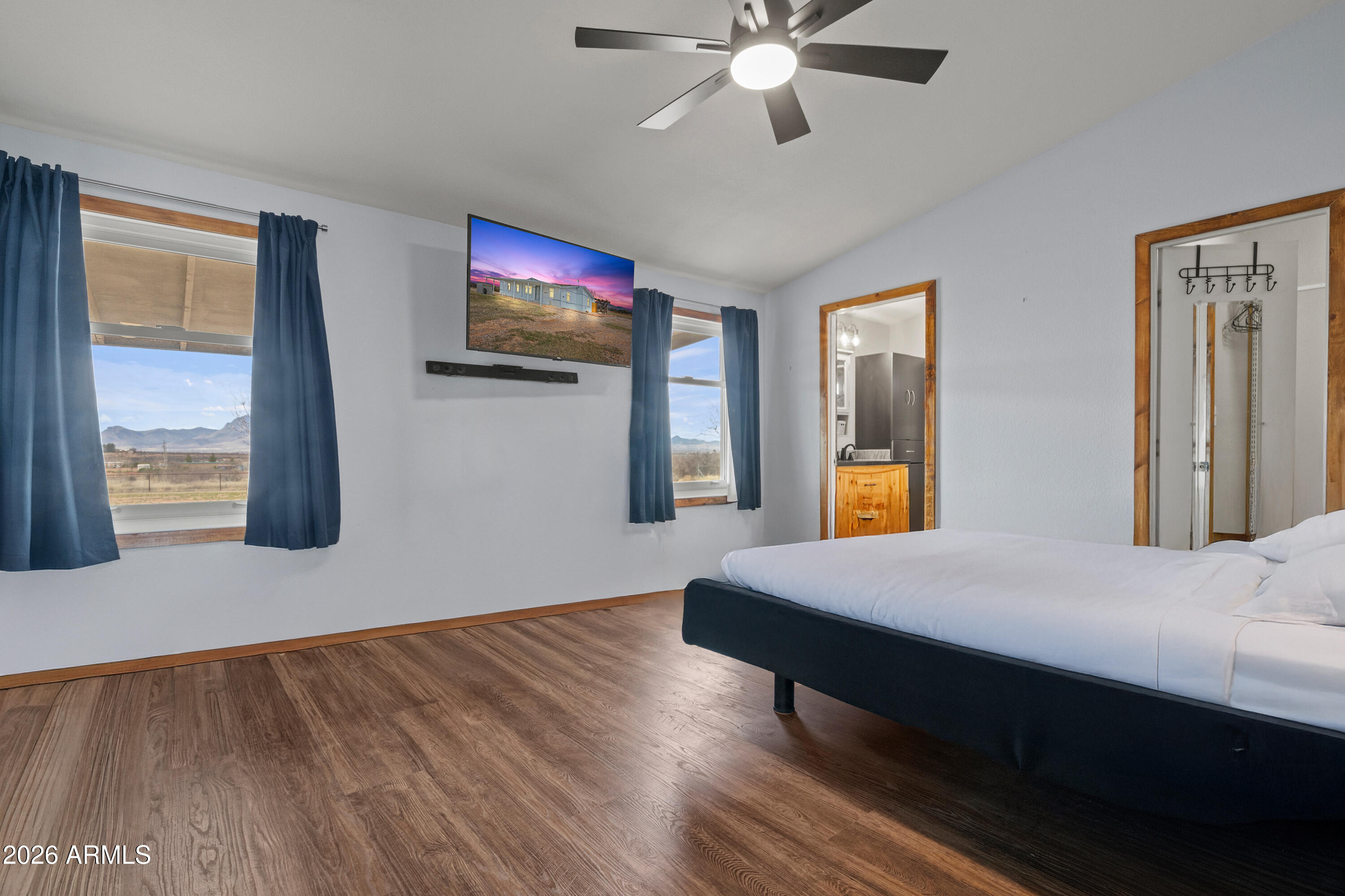 10072 South Shiloh Ranch Road Hereford, AZ 85615 - Photo 15 of 46 a bedroom with a bed and a flat screen tv