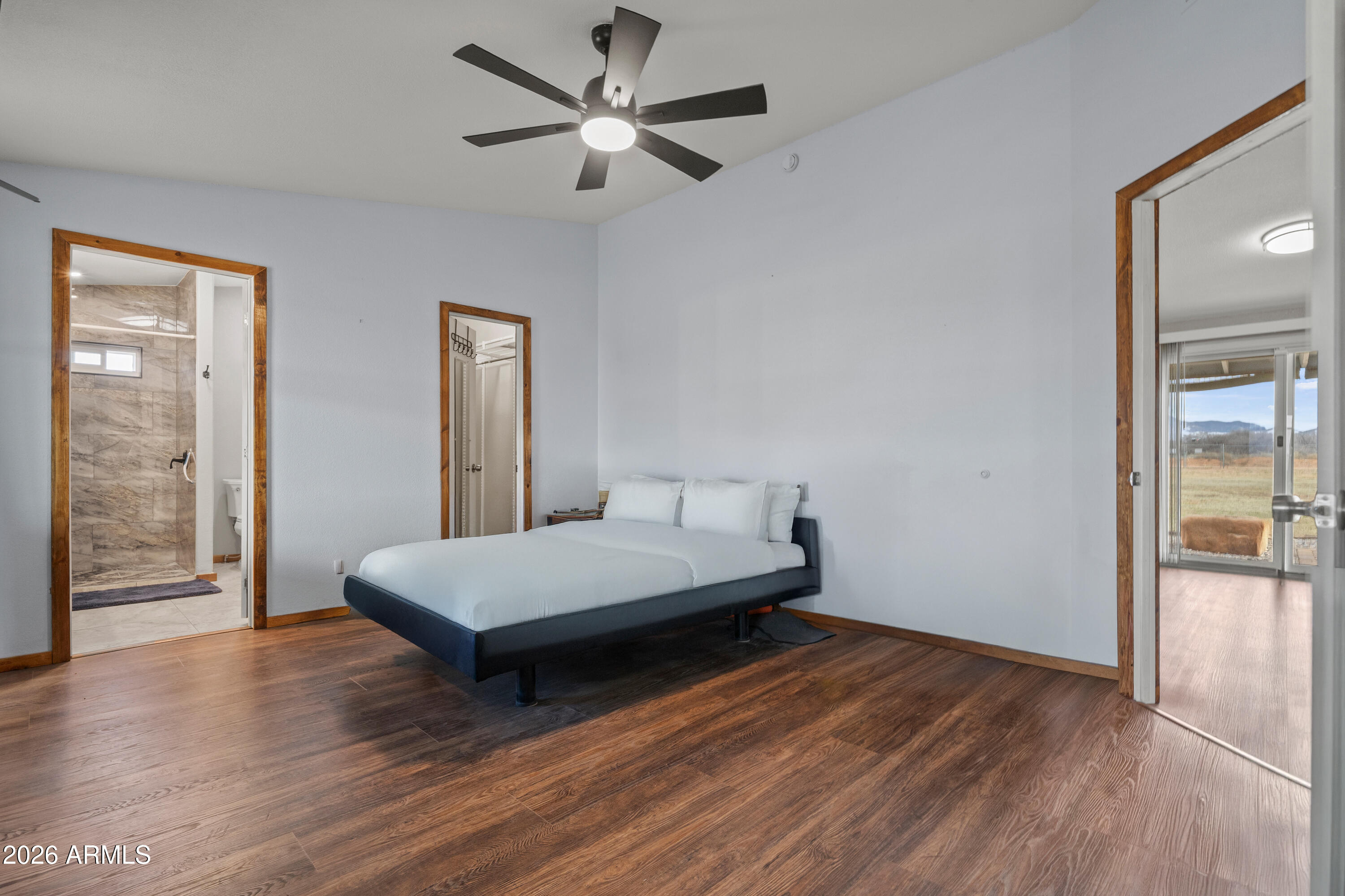 10072 South Shiloh Ranch Road Hereford, AZ 85615 - Photo 16 of 46 a living room with a bed furniture and a large window