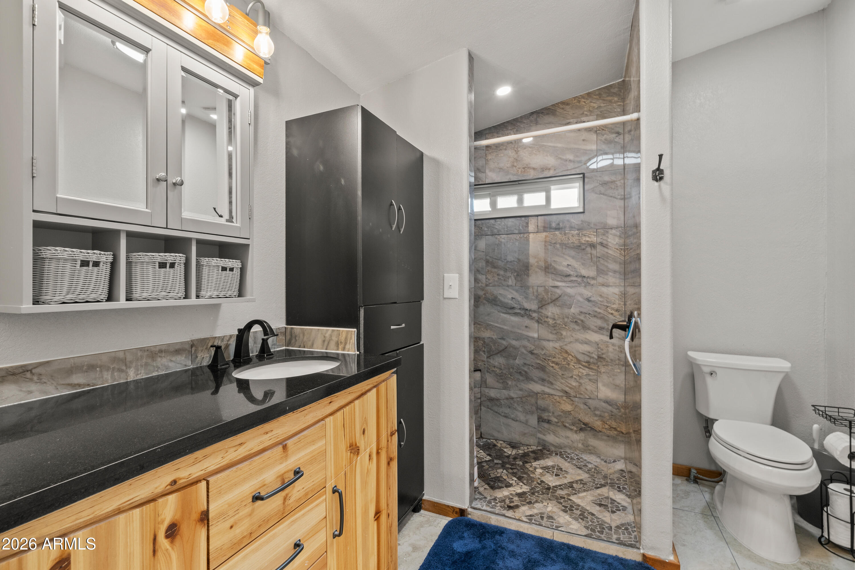 10072 South Shiloh Ranch Road Hereford, AZ 85615 - Photo 17 of 46 a bathroom with a granite countertop sink toilet and shower