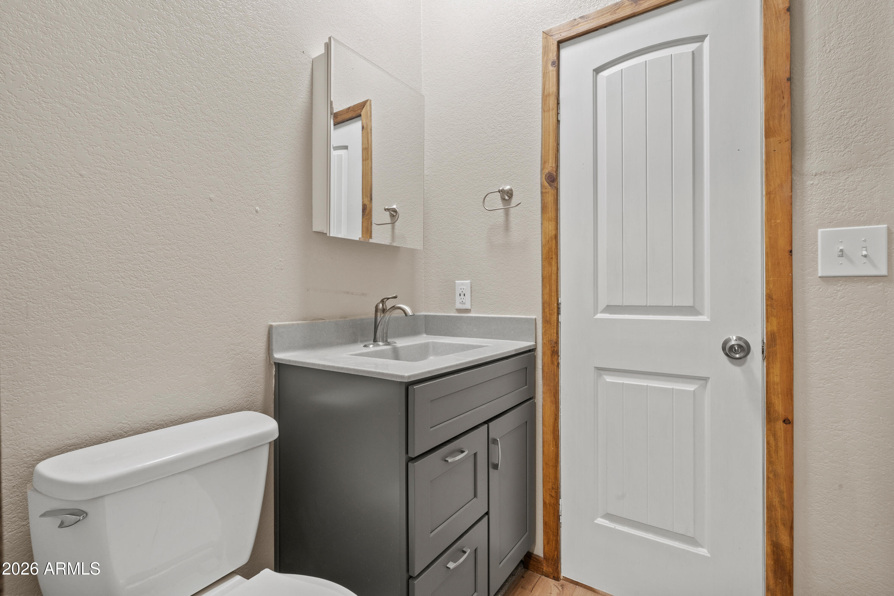 10072 South Shiloh Ranch Road Hereford, AZ 85615 - Photo 26 of 46 a bathroom with a toilet sink and mirror