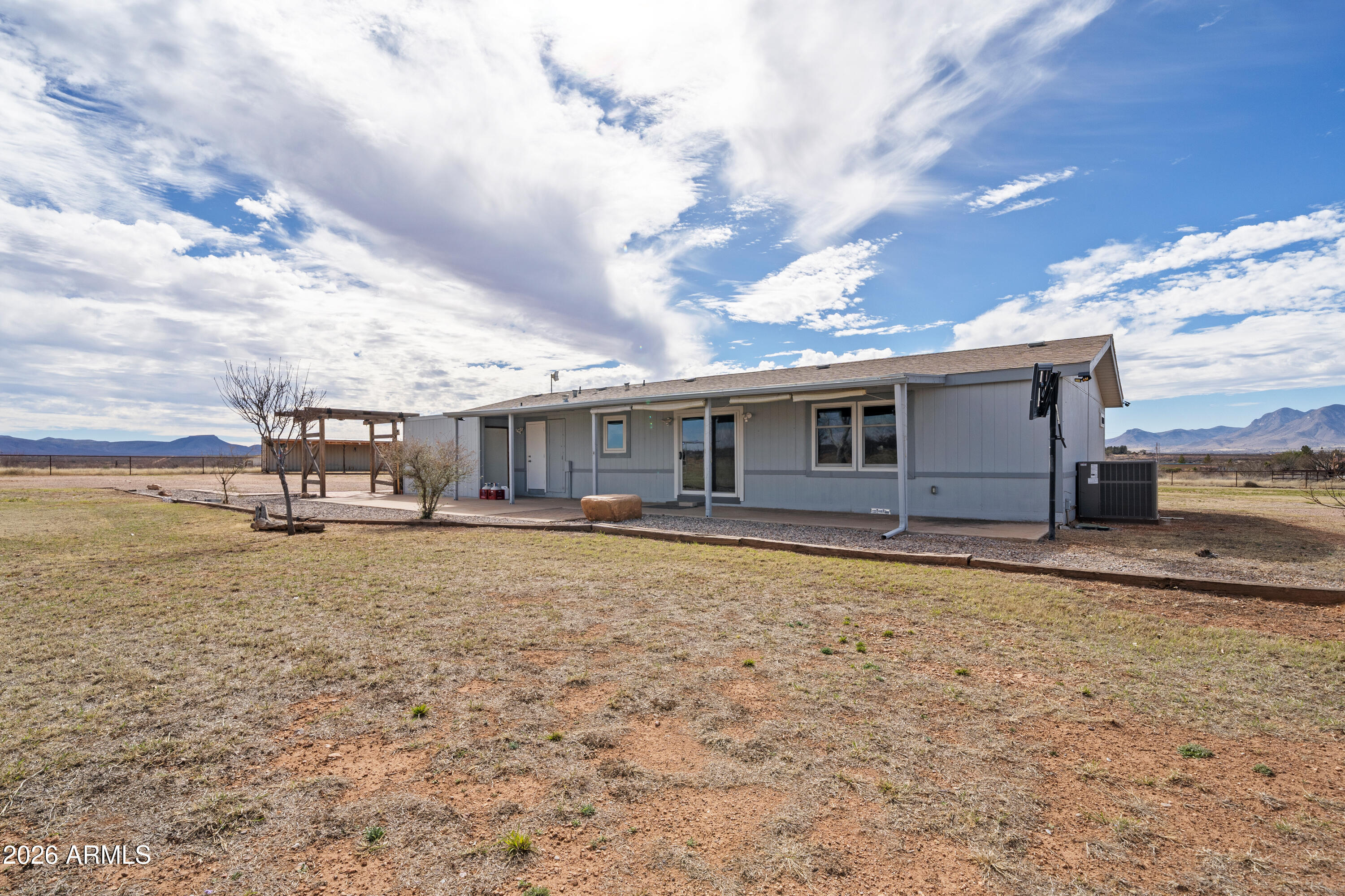10072 South Shiloh Ranch Road Hereford, AZ 85615 - Photo 28 of 46 a front view of a house with a garden