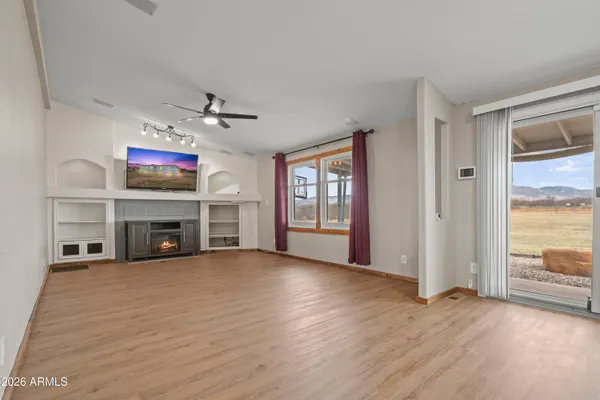 wooden floor in an empty room with a fireplace